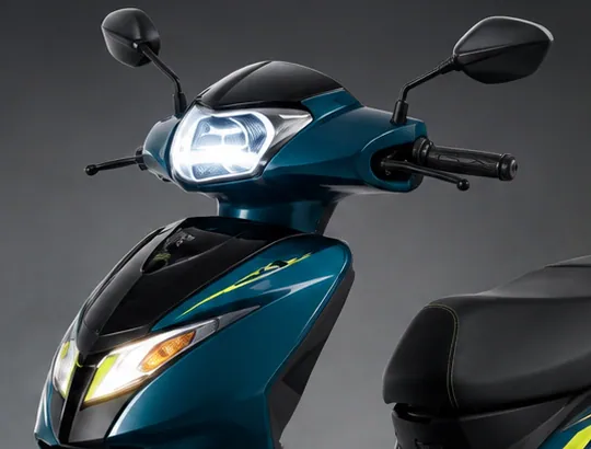 Front of the ZYX scooter with its headlamp lit